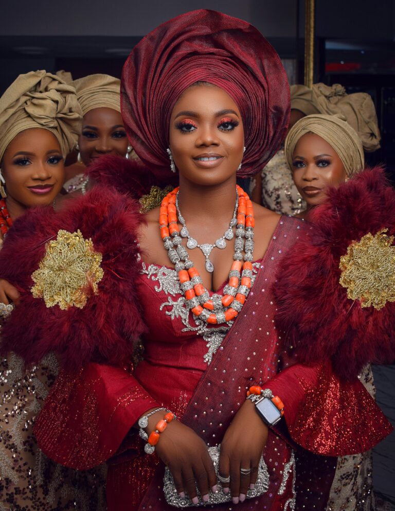 Nigerian bride and bridesmaids in traditional attire, featuring headwraps and elegant dresses.