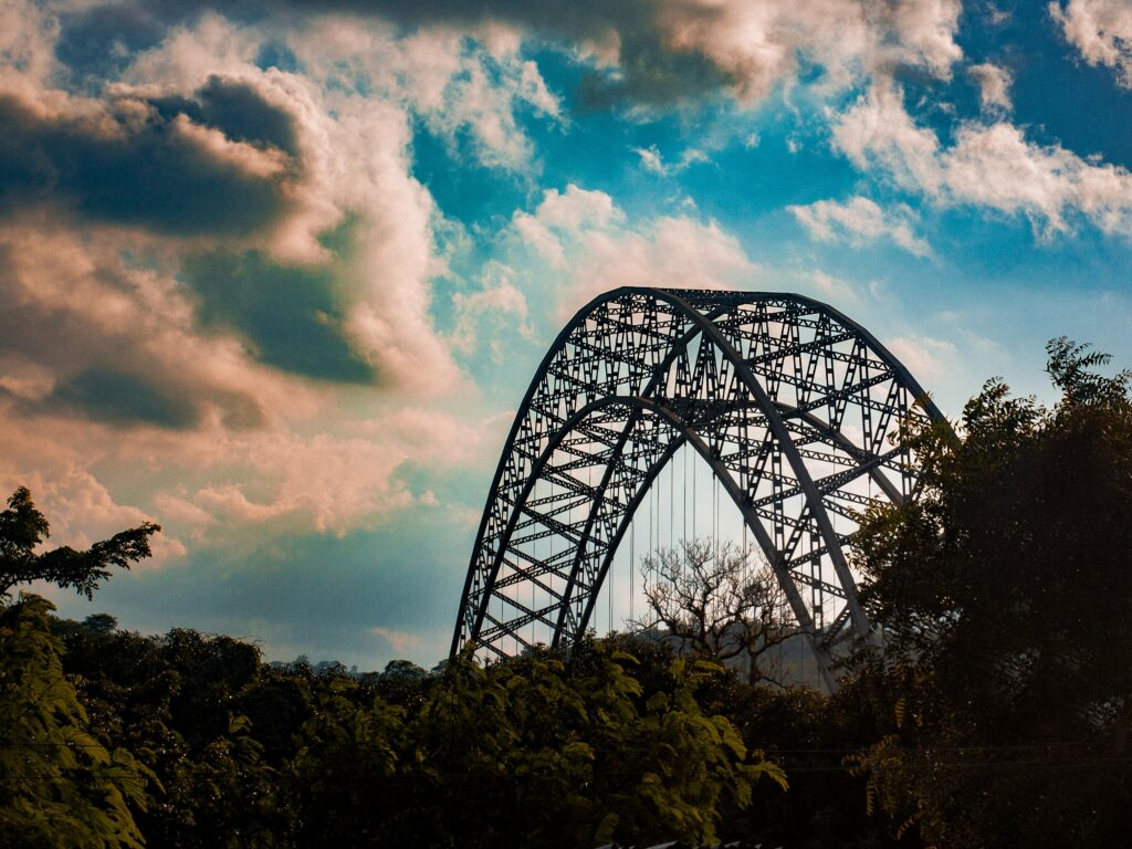 Stunning view of Adomi Bridge, Ghana with dramatic clouds in the backdrop, enhancing its architectural elegance.